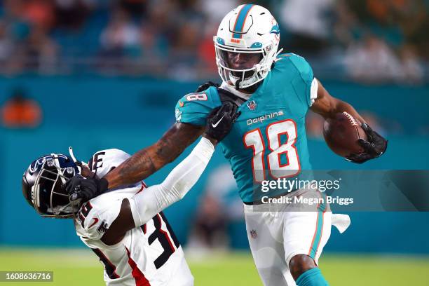 Erik Ezukanma of the Miami Dolphins stiff arms Breon Borders of the Atlanta Falcons during the second quarter in a preseason game at Hard Rock...