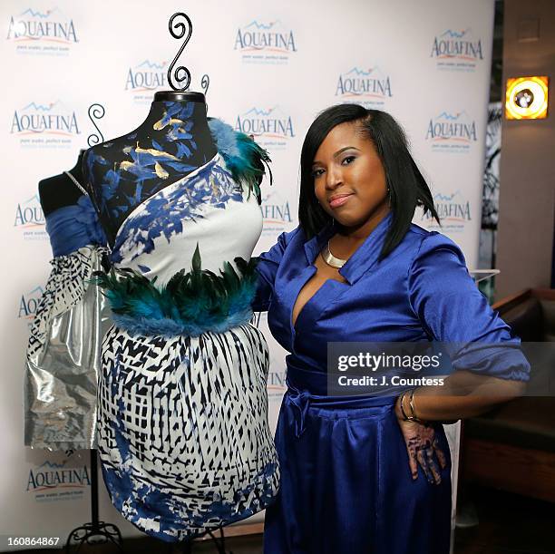 Designer Carmen Green of Baltimore, MD poses in front of her winning design after winning The Aquafina "Pure Challenge" at the Aquafina "Pure...