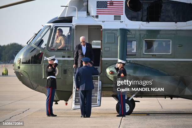 President Joe Biden steps off Marine One before boarding Air Force One at Joint Base Andrews in Maryland on August 18 as they depart for Lake Tahoe,...