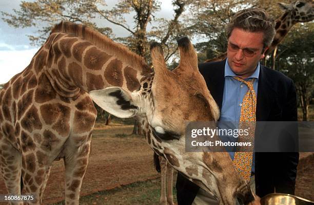 Prince Laurent of Belgium with a giraffe visits a project of the "Vets without Borders/Belgium" on June 18, 2000 on Comoros Island.