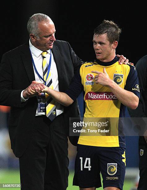 Mariners coach Graham Arnold embraces Michael McGlinchey after he was substituted during the round 20 A-League match between the Central Coast...