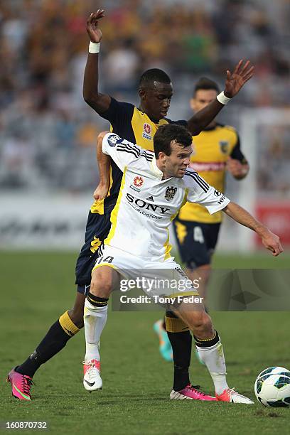 Ian Hogg of the Phoenix is pressured by Bernie Ibini of the Mariners during the round 20 A-League match between the Central Coast Mariners and the...