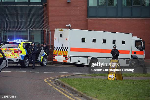 Armed police stand guard as Dale Cregan and nine other co-defendants arrive in an armed convoy to face charges of murder and attempted murder at...