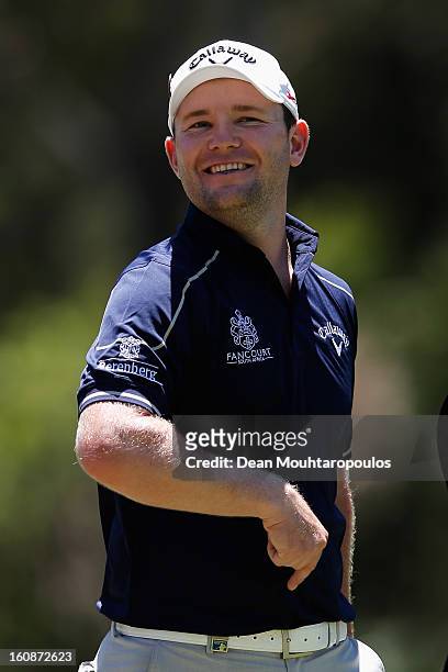 Branden Grace of South Africa smiles after he putts on the 3rd green during the Day One of the Joburg Open at Royal Johannesburg and Kensington Golf...