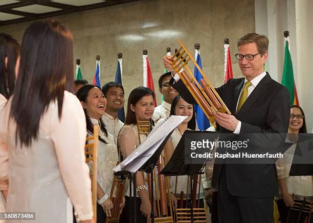 German Foreign Minister Guido Westerwelle speaks with anklung musicians ath the foreign ministry on February 7, 2013 in Manila, Philippines....