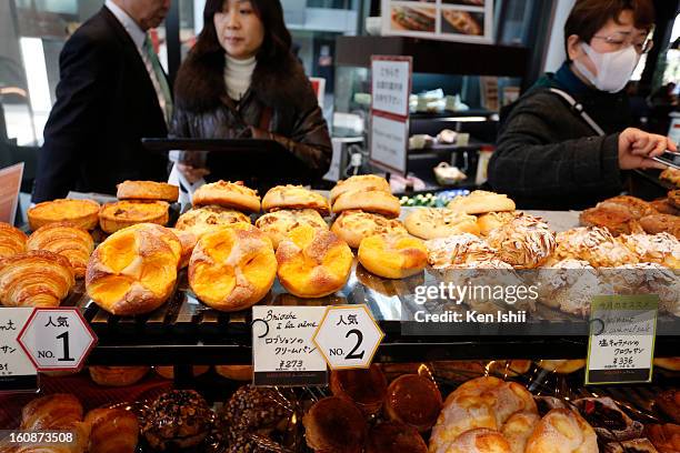 People grab breads on February 7, 2013 in Tokyo, Japan. A recent servey shows Tokyo as the most expensive city in the world and Osaka ranked second.