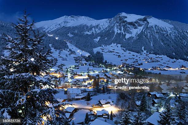 village of lenk, moonlight, fresh snow, time exposure - switzerland snow stock pictures, royalty-free photos & images