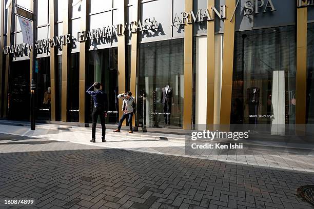 Man poses for photographs at Marunouchi business district on February 7, 2013 in Tokyo, Japan. A recent servey shows Tokyo as the most expensive city...