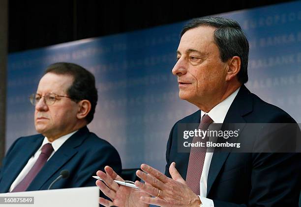Vitor Constancio, vice president of the European Central Bank, left, listens as Mario Draghi, president of the European Central Bank , speaks during...