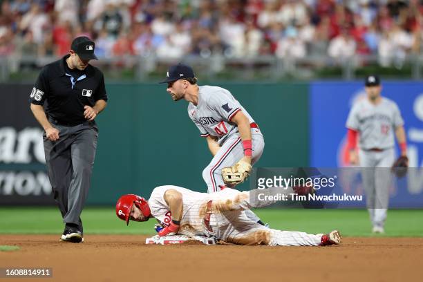 Trea Turner of the Philadelphia Phillies slides for a double past Edouard Julien of the Minnesota Twins during the seventh inning at Citizens Bank...