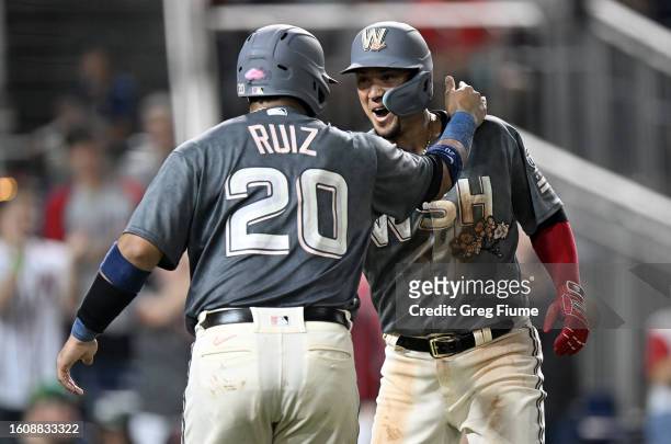 Ildemaro Vargas of the Washington Nationals celebrates with Keibert Ruiz after hitting a three-run home run in the seventh inning against the Oakland...