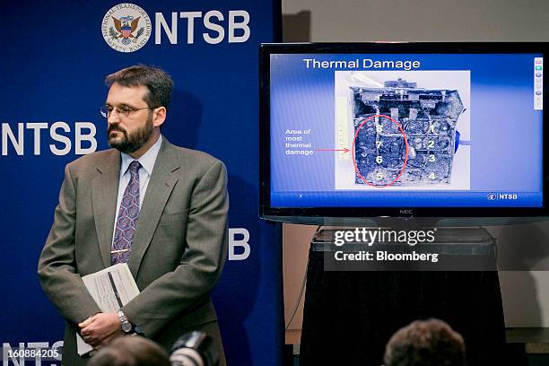 Joseph Kolly, director of research and engineering with the National Transportation Safety Board , stands next to a television displaying a damaged...