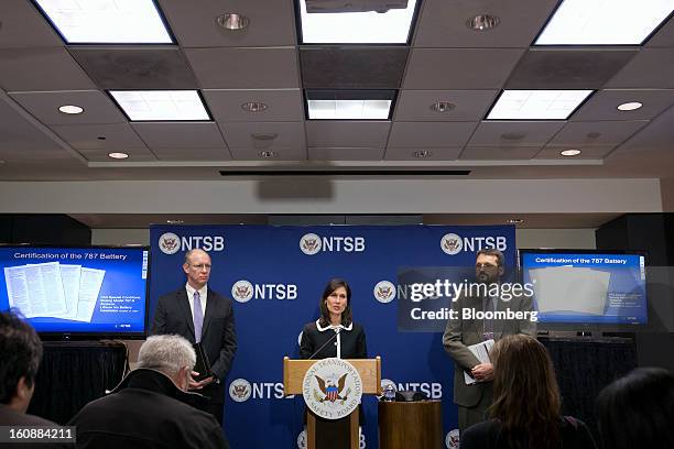 Deborah Hersman, chairman of the National Transportation Safety Board , center, speaks during a news conference with John DeLisi, director of...