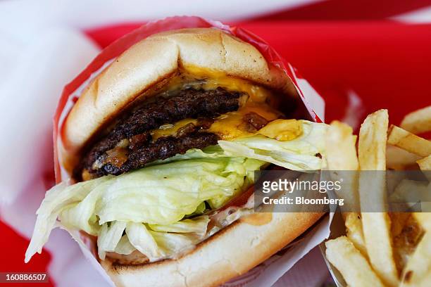 In-N-Out Burger's signature Double-Double cheeseburger and french fries are arranged for a photograph at a restaurant in Costa Mesa, California,...