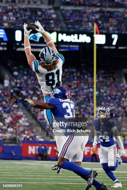Hayden Hurst of the Carolina Panthers leaps to make a catch as Tre Hawkins III of the New York Giants defends during the first half of a pre-season...