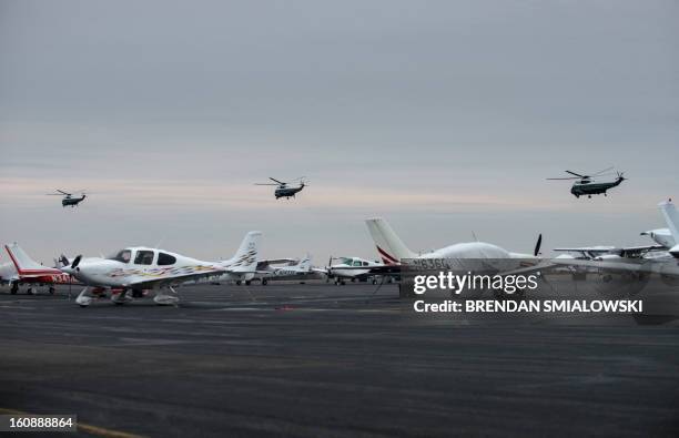 Marine One with US President Barack Obama takes off with two decoy helicopters at Leesburg Executive Airport February 7, 2013 in Leesburg, Virginia....