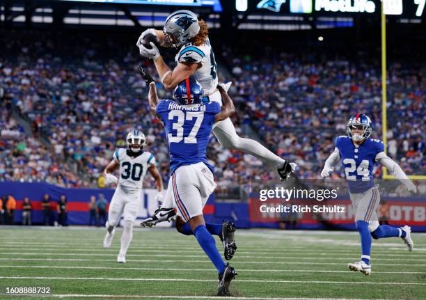 Hayden Hurst of the Carolina Panthers leaps to make a catch as Tre Hawkins III of the New York Giants defends during the first half of a pre-season...