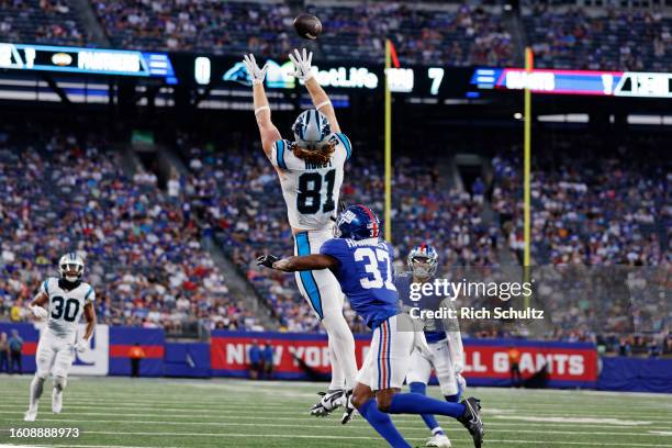 Hayden Hurst of the Carolina Panthers leaps to make a catch as Tre Hawkins III of the New York Giants defends during the first half of a pre-season...