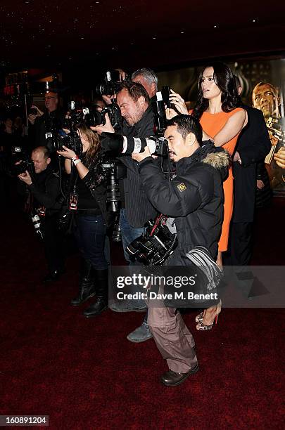 Emma Heming, wife of Bruce Willis, shoots pictures of her husband with press photographers at the UK Premiere of 'A Good Day To Die Hard' at Empire...