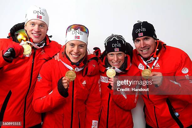 In this handout image provided by IBU, Tarjei Boe, Synnoeve Solemdal, Tora Berger and Emil Hegle Svendsen of Norway pose with their gold medals after...