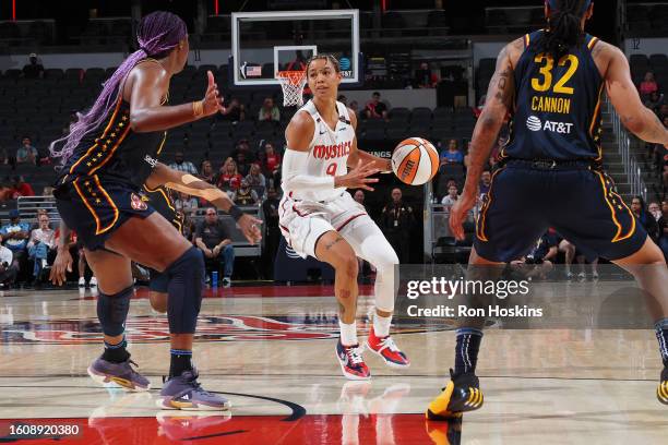 Natasha Cloud of the Washington Mystics dribbles the ball during the game against the Indiana Fever on August 18, 2023 at Gainbridge Fieldhouse in...