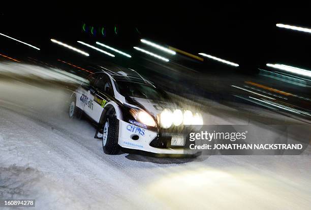 Sweden's Hasse Gustafsson and his co-driver Mikael Johansson steer their Ford Fiesta RS WRC during the 1st stage of the Rally Sweden, second round of...