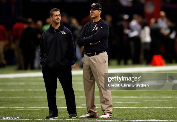 Head coach John Harbaugh of the Baltimore Ravens and head coach Jim Harbaugh of the San Francisco 49ers talk on the field during Super Bowl XLVII at...