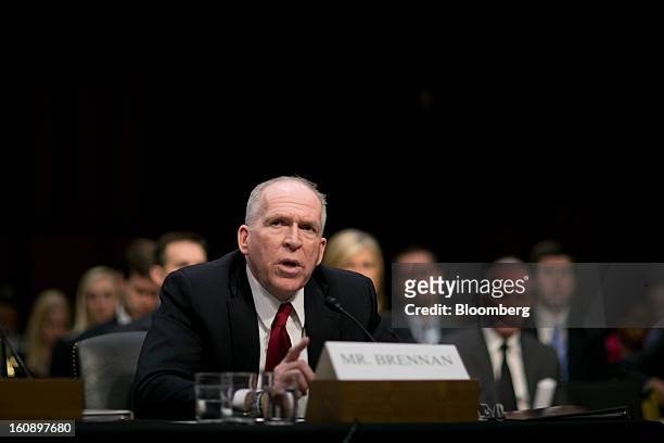 John Brennan, nominee for director of the Central Intelligence Agency and White House chief counterterrorism adviser, center, speaks during a Senate...