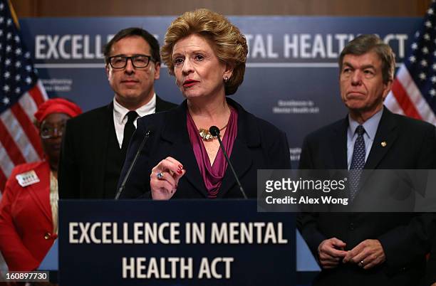 Senator Debbie Stabenow speaks as David O. Russell, director of the film Silver Linings Playbook, and Senator Roy Blunt look on during a news...