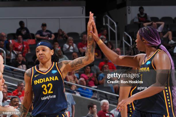 Emma Cannon and Aliyah Boston of the Indiana Fever high five during the game against the Washington Mystics on August 18, 2023 at Gainbridge...