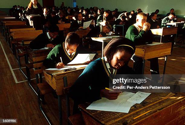 Black and white students take a test June 21, 2001 at Vryburg High School in Vryburg, South Africa. Vryburg, a small and very conservative farming...