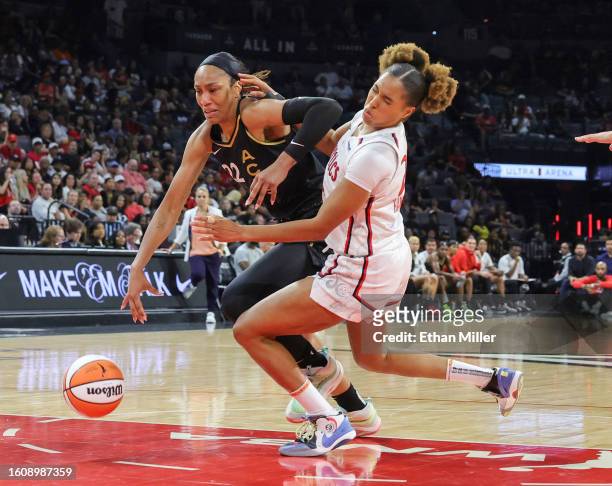 Ja Wilson of the Las Vegas Aces drives to the basket as Tianna Hawkins of the Washington Mystics falls to the court in the fourth quarter of their...