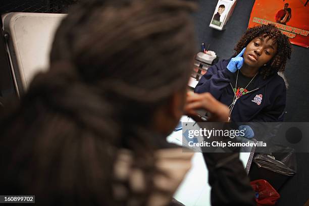 Community Health Educator Nanah Fofanah guides a young man through an oral HIV test inside the Whitman-Walker Health mobile testing site as part of...