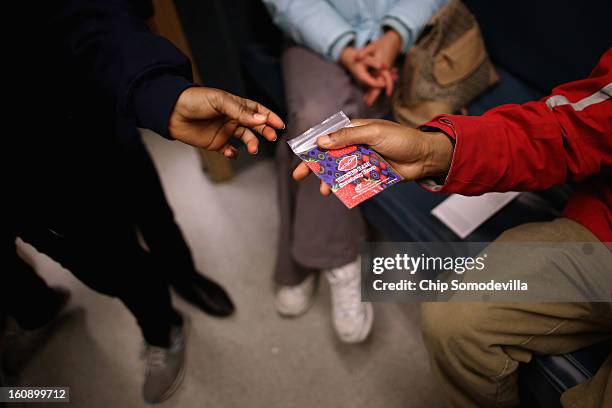 Community health educator gives away free prophylactics inside the Whitman-Walker Health mobile testing vehicle as part of National Black HIV/AIDS...