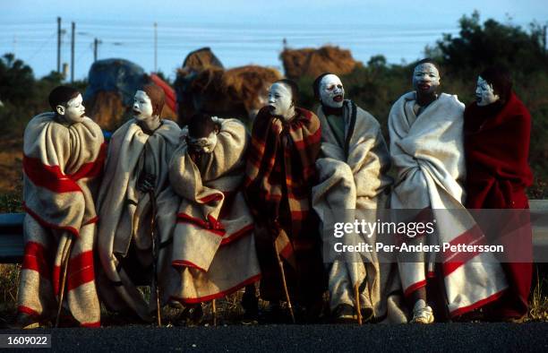 Young Xhosa boys, their faces smeared with clay as part of a manhood ritual, stand on the side of the N2 highway July 9, 2001 Mdantsane outside East...