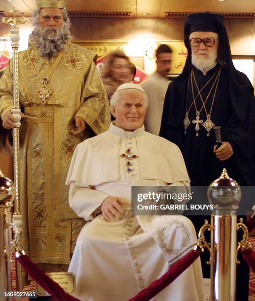 People look at wax figures of Pope John Paul II , Greek Orthodox Patriarch Ignatius IV Hazim and 19th century Greek Catholic Patriarch Maximus Mazlum...