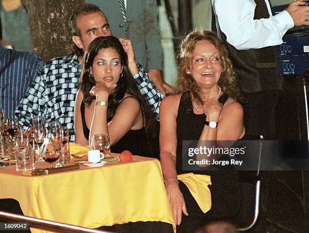 Dalia Soto del Valle sits with her and Fidel Castro''s son, Alexander , and an unidentified friend during the Habanos SA event February 2001 at the...