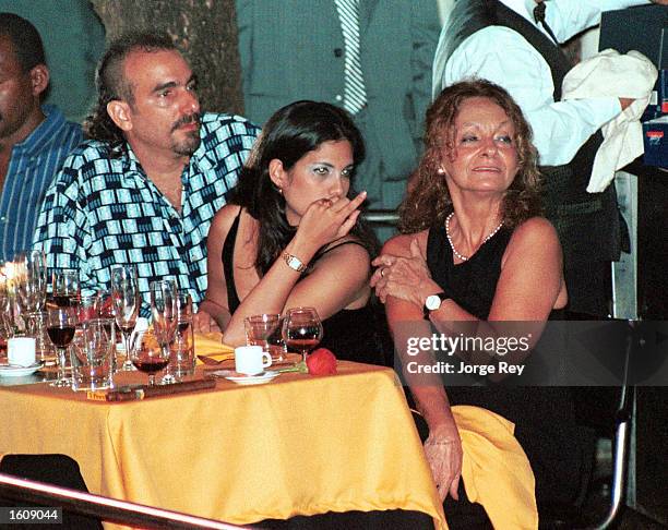 Dalia Soto del Valle sits with her and Fidel Castro''s son, Alexander , and an unidentified friend during the Habanos SA event February 2001 at the...