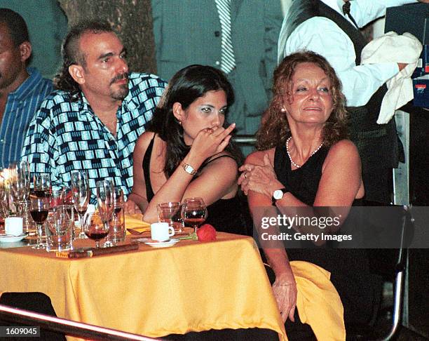 Dalia Soto del Valle sits with her and Fidel Castro''s son, Alexander , and an unidentified friend during the Habanos SA event February 2001 at the...