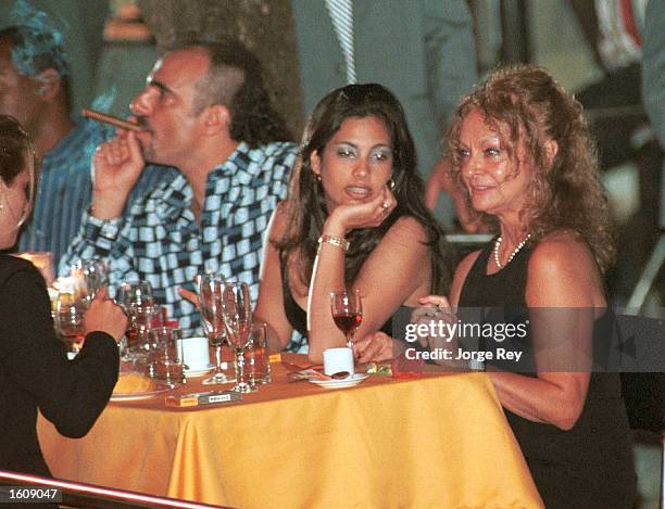 Dalia Soto del Valle sits with her and Fidel Castro''s son, Alexander , and an unidentified friend during the Habanos SA event February 2001 at the...