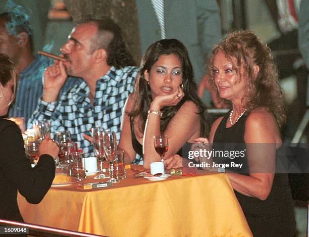 Dalia Soto del Valle sits with her and Fidel Castro''s son, Alexander , and an unidentified friend during the Habanos SA event February 2001 at the...