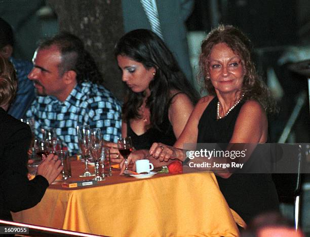 Dalia Soto del Valle sits with her and Fidel Castro''s son, Alexander , and an unidentified friend during the Habanos SA event February 2001 at the...