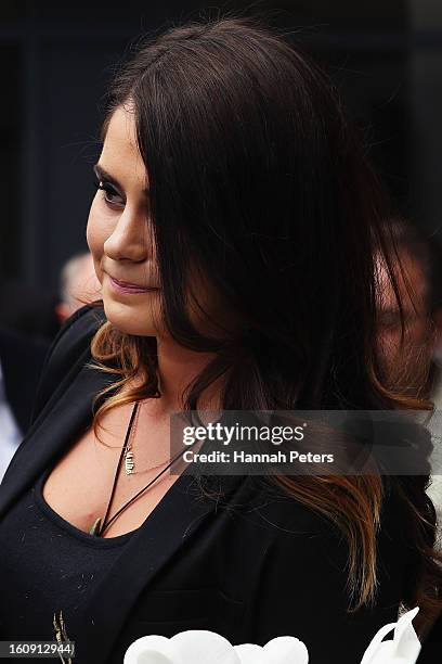 Daughter of Sir Paul Holmes, Millie Elder-Holmes carries her father's coffin out at Auckland Cathedral of the Holy Trinity in Parnell on February 8,...