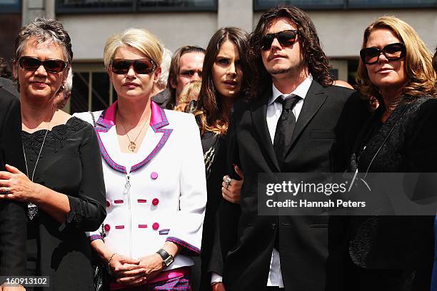 Widow of Sir Paul Holmes, Lady Deborah Holmes and children of Sir Paul Holmes, Millie Elder-Holmes and Reuben Holmes look on as the hearse drives...