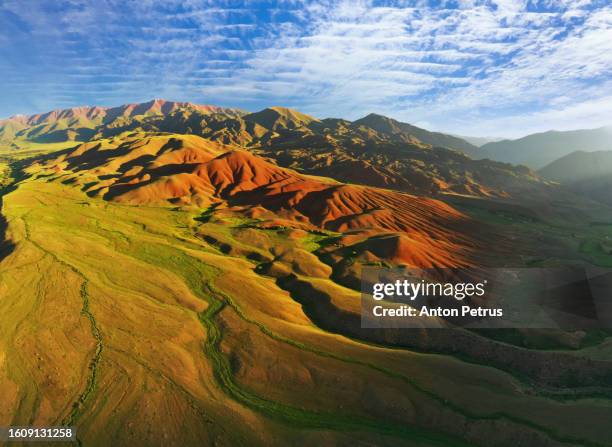 aerial view of mountain landscape in kyrgyzstan at sunset. - montañas de tien shan fotografías e imágenes de stock