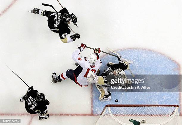 Marc-Andre Fleury of the Pittsburgh Penguins protects the net against Eric Fehr of the Washington Capitals during the game at Consol Energy Center on...