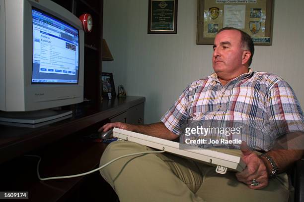 Special Agent Don Condon from the Florida Department of Law Enforcement uses an AOL account on his computer August 14, 2001 to bring online...