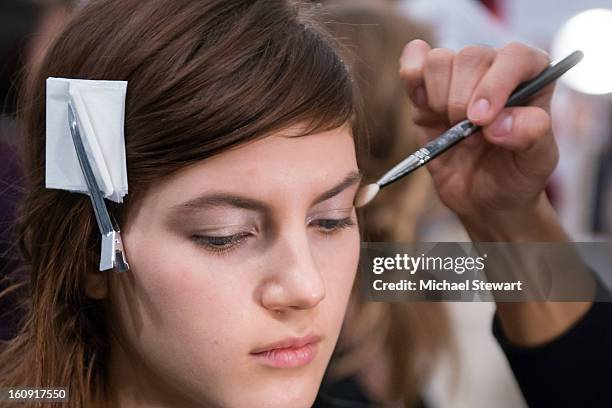 Model prepares backstage at Tadashi Shoji fashion show during Fall 2013 Mercedes-Benz Fashion Week at The Stage at Lincoln Center on February 7, 2013...