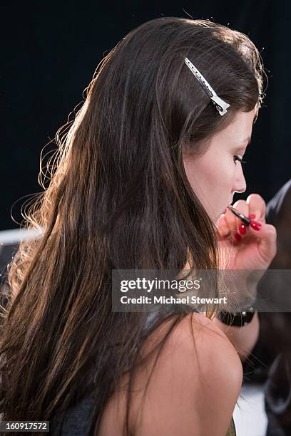 Model prepares backstage at Tadashi Shoji fashion show during Fall 2013 Mercedes-Benz Fashion Week at The Stage at Lincoln Center on February 7, 2013...