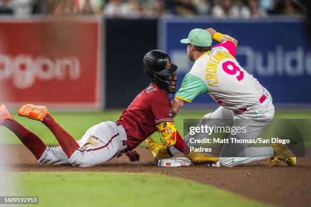 Jake Cronenworth of the San Diego Padres tags out a runner trying to advance to second base in the seventh inning against the Arizona Diamondbacks on...